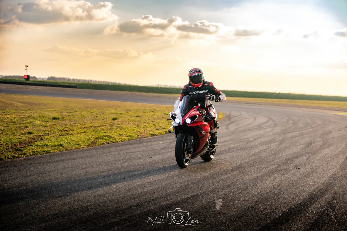 Un pilote rejoint la piste au guidon de sa moto sportive.